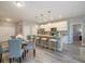 Open layout connecting a modern kitchen with a breakfast bar to a comfortable dining area at 0 Paddock St, Orlando, FL 32833