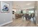 Inviting living space with modern flooring, leading to a kitchen with a breakfast bar and dining area at 0 Paddock St, Orlando, FL 32833