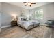 Cozy main bedroom showcasing a plush bed, soft lighting, and a view of the outdoors through a window at 0 Paddock St, Orlando, FL 32833