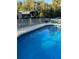 Inviting blue swimming pool with a wooden deck and fenced area at 12680 Sw 98Th St, Dunnellon, FL 34432