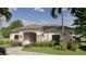 Inviting single-story home with stone accents, lush landscaping, and covered entry at 2007 Iorio St, St Cloud, FL 34771