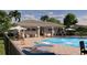 Community pool area featuring ample seating, lounge chairs, and outdoor grill at 2007 Iorio St, St Cloud, FL 34771
