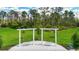 Outdoor seating on backyard patio in serene setting, surrounded by lush greenery and trees at 2479 Pine Preserve Ct, St Cloud, FL 34771