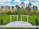 Backyard featuring a pergola swing and manicured landscaping providing a private oasis at 2479 Pine Preserve Ct, St Cloud, FL 34771