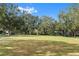 Expansive community green space lined with mature trees, perfect for relaxation and recreation at 2608 Meeting Pl # 14-101, Orlando, FL 32814