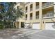 Apartment complex featuring private garages and balconies, blending convenience and outdoor living at 2608 Meeting Pl # 101, Orlando, FL 32814