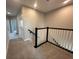 Upstairs hallway with carpet, black railing and white spindles at 5318 Center Lake Ranch Blvd, St Cloud, FL 34771