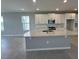 Bright kitchen featuring white cabinets, stainless steel appliances, a large island, and tile flooring at 5318 Center Lake Ranch Blvd, St Cloud, FL 34771