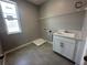 Practical laundry room with sink, cabinets, and ample space for a washer and dryer at 5318 Center Lake Ranch Blvd, St Cloud, FL 34771