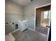 Functional laundry room equipped with a utility sink, storage cabinets, and washer/dryer hookups at 5318 Center Lake Ranch Blvd, St Cloud, FL 34771