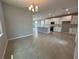 Open concept living space featuring a kitchen with white cabinets at 5318 Center Lake Ranch Blvd, St Cloud, FL 34771