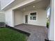 Covered outdoor patio boasts brick pavers and offers a private space for relaxing or entertaining guests at 5318 Center Lake Ranch Blvd, St Cloud, FL 34771