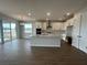 Bright, open kitchen with white cabinets, island, and stainless steel appliances at 5379 Park Guell St, St Cloud, FL 34771