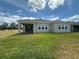 Expansive backyard with lush green lawn and covered patio, perfect for outdoor entertaining at 5379 Park Guell St, St Cloud, FL 34771