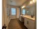 Luxurious Primary bathroom with double vanity sinks, and a glass-enclosed shower, providing ample space and comfort at 5379 Park Guell St, St Cloud, FL 34771