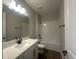 Contemporary bathroom with a sleek vanity, elegant mirror, and a pristine white tiled shower-tub combination at 5379 Park Guell St, St Cloud, FL 34771