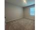 Carpeted bedroom features neutral paint and a window at 5379 Park Guell St, St Cloud, FL 34771