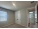 Neutral bedroom with window and closet with bi-fold doors at 5379 Park Guell St, St Cloud, FL 34771