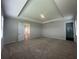 Large main bedroom with tray ceiling and a door that leads to the bathroom at 5379 Park Guell St, St Cloud, FL 34771