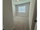 Neutral colored bedroom with carpet, window and neutral colored walls at 5379 Park Guell St, St Cloud, FL 34771