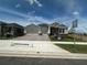 Charming home featuring a three-car garage and a beautifully landscaped front yard at 5379 Park Guell St, St Cloud, FL 34771