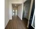 Wood-look flooring leads through a neutral hallway at 5379 Park Guell St, St Cloud, FL 34771
