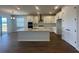 Bright modern kitchen with sleek white cabinetry, stainless steel appliances, and a large center island at 5379 Park Guell St, St Cloud, FL 34771