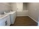 Well-equipped laundry room with modern washer, dryer, and cabinetry for storage and functionality at 5379 Park Guell St, St Cloud, FL 34771