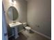 Clean, modern powder room featuring a pedestal sink and sleek fixtures at 5385 Park Guell St, St Cloud, FL 34771
