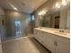 Elegant Primary bathroom with a double vanity, walk-in shower, and modern tile at 5385 Park Guell St, St Cloud, FL 34771