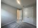 Cozy bedroom with neutral carpet, double doors, and ample closet space at 5385 Park Guell St, St Cloud, FL 34771