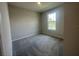 Bright bedroom with a large window and neutral carpet, offering a calm retreat at 5385 Park Guell St, St Cloud, FL 34771