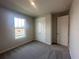 Comfortable bedroom featuring soft carpet, a large window, and closet space at 5385 Park Guell St, St Cloud, FL 34771