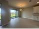 Bright dining area with tile flooring, modern chandelier, and sliding glass doors to the backyard at 5385 Park Guell St, St Cloud, FL 34771