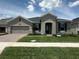 Charming single-story home featuring a well-manicured lawn and neutral-toned exterior at 5385 Park Guell St, St Cloud, FL 34771