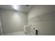 The laundry room features a white sink and cabinet, as well as a wire rack for storage at 5385 Park Guell St, St Cloud, FL 34771