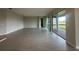 An open-concept living area with tile flooring and sliding glass doors at 5385 Park Guell St, St Cloud, FL 34771