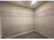 A large walk-in closet with wire shelving along the walls, offering ample storage space at 5385 Park Guell St, St Cloud, FL 34771