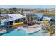 Aerial view of a community clubhouse with pools, palm trees, and modern amenities, creating a resort-style ambiance at 7916 Waterfield Ave, Orlando, FL 32832
