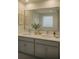 Elegant bathroom with double vanity, framed mirror, and neutral color palette, offering a serene ambiance at 7916 Waterfield Ave, Orlando, FL 32832