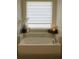 Soaking tub with tiled surround, creating a tranquil and relaxing retreat with natural light at 7916 Waterfield Ave, Orlando, FL 32832