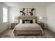 Inviting primary bedroom featuring tufted headboard, neutral tones, and stylish nightstands with lamps at 7916 Waterfield Ave, Orlando, FL 32832