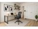 Stylish home office with desk, chair, floating shelves, and decor, creating a functional workspace at 7916 Waterfield Ave, Orlando, FL 32832