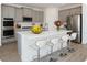 Modern kitchen with gray cabinetry, stainless steel appliances, an island with seating, and a stylish design at 7916 Waterfield Ave, Orlando, FL 32832