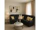 Cozy living room with a black leather sectional, gold accents, and a modern aesthetic creating a comfortable space at 7916 Waterfield Ave, Orlando, FL 32832