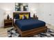 Comfortable bedroom featuring a wood bed frame, stylish nightstands, and contemporary decor creating a serene retreat at 7916 Waterfield Ave, Orlando, FL 32832