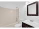 Standard bathroom featuring a shower-tub combo, toilet, vanity and a framed mirror at 916 Derbyshire Dr, Kissimmee, FL 34758