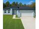 Charming single-story home boasts a manicured lawn and attached two-car garage at 13739 Sw 43Rd Cir, Ocala, FL 34473
