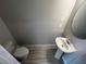 Cozy bathroom with a pedestal sink, toilet, and tile flooring at 5086 Rain Shadow Dr, St Cloud, FL 34772