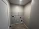 Functional laundry room with a wire rack and tile floors at 5086 Rain Shadow Dr, St Cloud, FL 34772